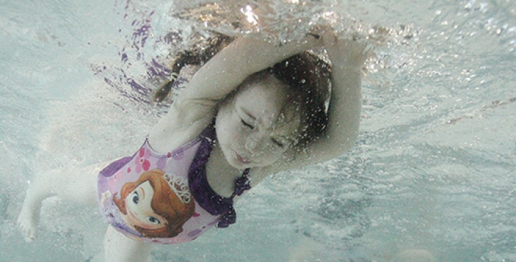 Little girl swimming under water