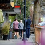 Residents walk down a street in Estevan Village in Oak Bay, lined with Oak Bay Businesses.